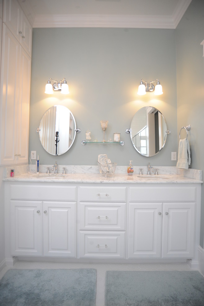 Mid-sized country master white tile and porcelain tile porcelain tile bathroom photo in Other with an undermount sink, raised-panel cabinets, white cabinets, marble countertops and white walls