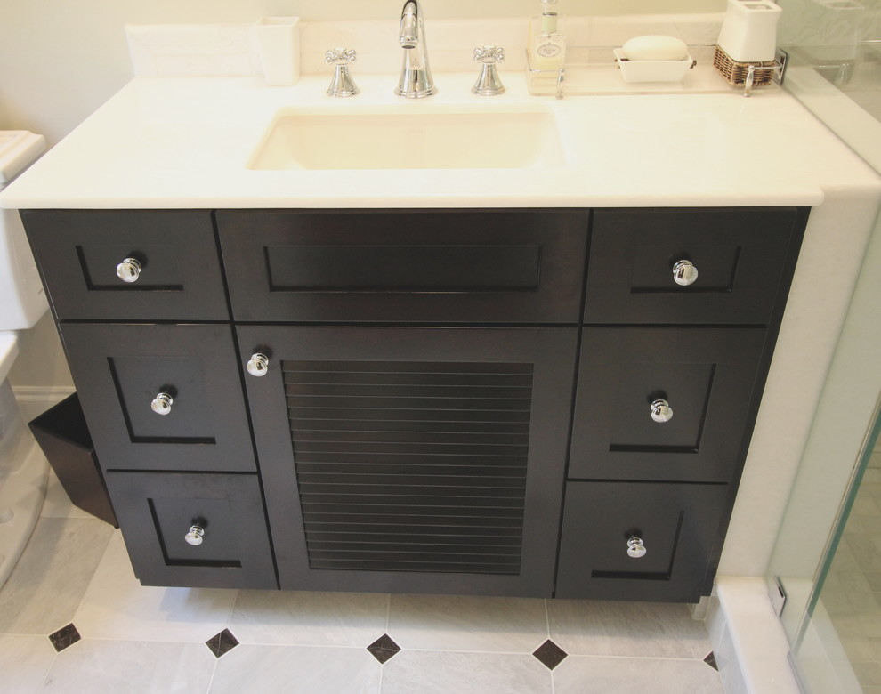 Example of a mid-sized transitional master marble floor bathroom design in St Louis with an undermount sink and dark wood cabinets