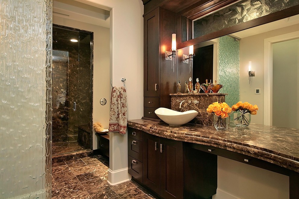 Example of a large classic master brown tile marble floor alcove shower design in Chicago with shaker cabinets, dark wood cabinets, gray walls, a vessel sink and marble countertops