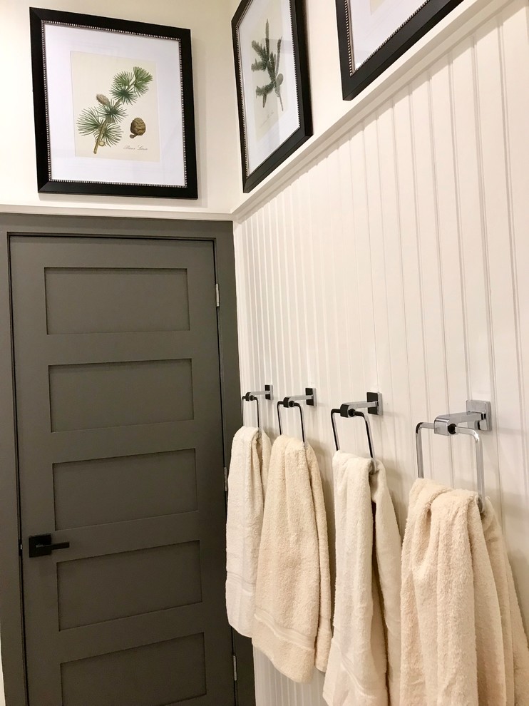 Example of a small cottage kids' beige tile and ceramic tile porcelain tile and beige floor tub/shower combo design in Philadelphia with recessed-panel cabinets, distressed cabinets, a one-piece toilet, white walls, a drop-in sink, quartz countertops, a hinged shower door and white countertops