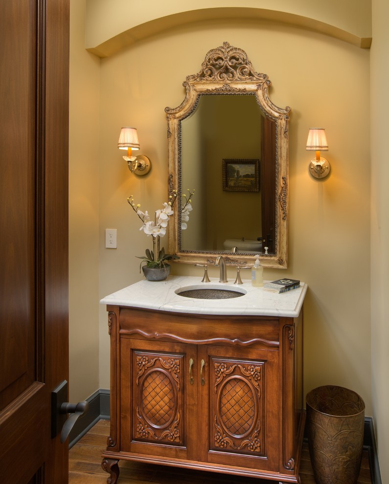 Inspiration for a timeless bathroom remodel in Columbus with an undermount sink, furniture-like cabinets, brown cabinets and marble countertops