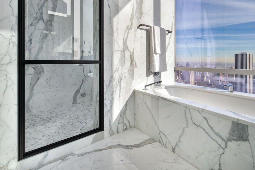 Inspiration for an expansive modern ensuite bathroom in New York with a built-in bath, a double shower, white walls, marble flooring, marble worktops and stone tiles.