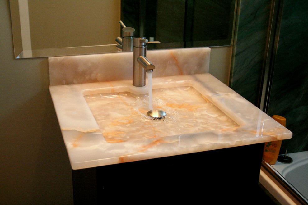 Example of a small trendy 3/4 limestone floor bathroom design in Los Angeles with an integrated sink, flat-panel cabinets, dark wood cabinets and beige walls