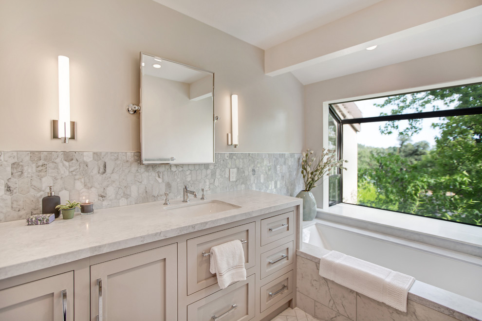 Inspiration for a mid-sized timeless master gray tile and marble tile marble floor and white floor bathroom remodel in San Francisco with shaker cabinets, beige cabinets, an undermount tub, beige walls, an undermount sink, marble countertops and white countertops