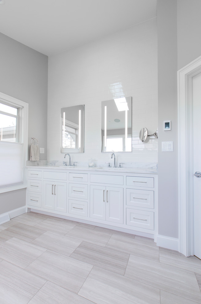 Inspiration for a mid-sized scandinavian master white tile and ceramic tile marble floor and gray floor bathroom remodel in Cleveland with white cabinets, a one-piece toilet, gray walls, an undermount sink, quartzite countertops, a hinged shower door and white countertops