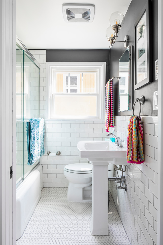 Inredning av ett modernt litet badrum, med ett badkar i en alkov, en dusch/badkar-kombination, en toalettstol med separat cisternkåpa, vit kakel, tunnelbanekakel, svarta väggar, klinkergolv i porslin, ett piedestal handfat, vitt golv och dusch med skjutdörr