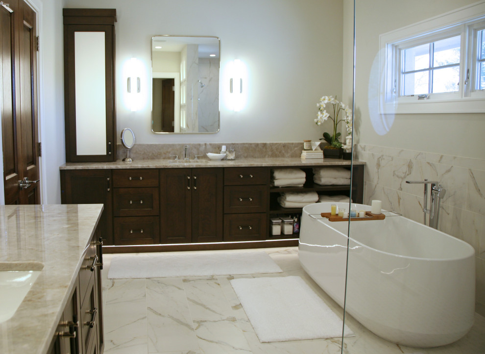 Large contemporary ensuite bathroom in Milwaukee with flat-panel cabinets, dark wood cabinets, a freestanding bath, a walk-in shower, a one-piece toilet, brown tiles, ceramic tiles, beige walls, ceramic flooring, a submerged sink, quartz worktops, beige floors, an open shower, white worktops, an enclosed toilet, double sinks and a built in vanity unit.