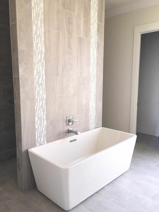 Freestanding bathtub - mid-sized transitional master brown tile and porcelain tile porcelain tile and gray floor freestanding bathtub idea in New Orleans with beige walls
