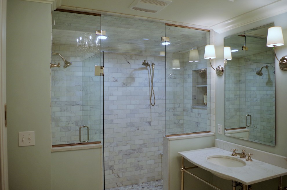 Corner shower - mid-sized traditional master porcelain tile and multicolored floor corner shower idea in St Louis with raised-panel cabinets, medium tone wood cabinets, gray walls, an integrated sink, onyx countertops and a hinged shower door
