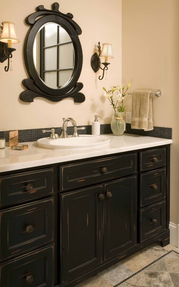Design ideas for a small classic bathroom in Seattle with a built-in sink, recessed-panel cabinets, distressed cabinets, black tiles, mosaic tiles, beige walls and porcelain flooring.