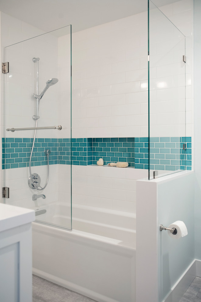 Photo of a medium sized contemporary family bathroom in San Francisco with shaker cabinets, white cabinets, an alcove bath, a shower/bath combination, a two-piece toilet, white tiles, ceramic tiles, blue walls, porcelain flooring, a submerged sink, engineered stone worktops, grey floors, a hinged door and white worktops.