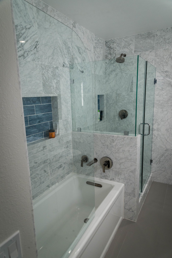 This is an example of a medium sized scandinavian ensuite bathroom in Los Angeles with flat-panel cabinets, medium wood cabinets, a built-in bath, a corner shower, a one-piece toilet, white tiles, marble tiles, white walls, porcelain flooring, a submerged sink, engineered stone worktops, grey floors and a hinged door.