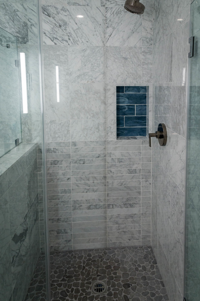 Mid-sized danish master white tile and marble tile porcelain tile and gray floor bathroom photo in Los Angeles with flat-panel cabinets, medium tone wood cabinets, a one-piece toilet, white walls, an undermount sink, quartz countertops and a hinged shower door