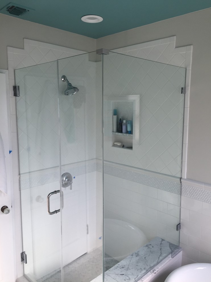 Cette image montre une salle de bain principale minimaliste de taille moyenne avec un lavabo encastré, des portes de placard blanches, un plan de toilette en granite, une baignoire sur pieds, une douche d'angle, un carrelage blanc, des carreaux de céramique, un mur gris et un sol en carrelage de céramique.