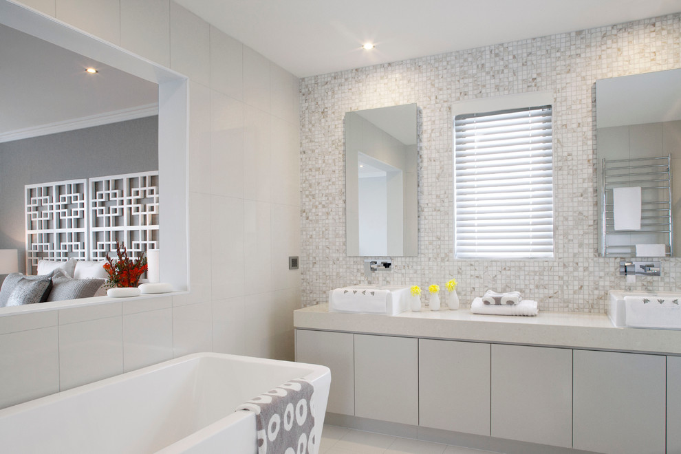 Modelo de cuarto de baño contemporáneo con bañera exenta y baldosas y/o azulejos en mosaico