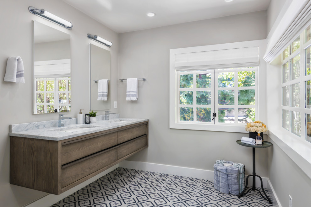 Mid-sized farmhouse master white tile and ceramic tile ceramic tile and white floor alcove shower photo in San Francisco with flat-panel cabinets, distressed cabinets, a wall-mount toilet, gray walls, an undermount sink, marble countertops, a hinged shower door and gray countertops