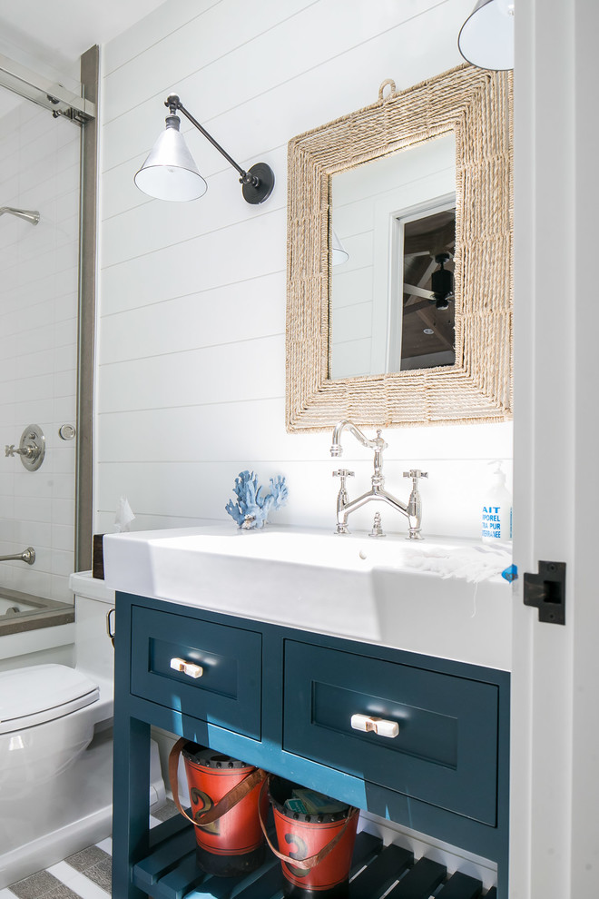 Inspiration for a mid-sized tropical kids' white tile and subway tile bathroom remodel in Orange County with shaker cabinets, blue cabinets, white walls, an integrated sink and white countertops