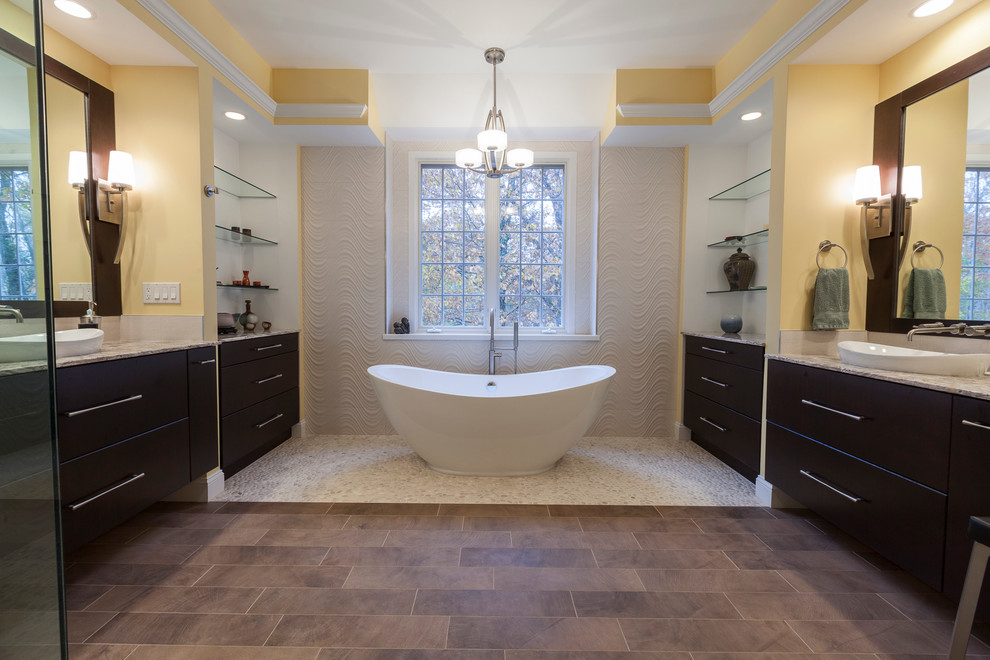 Inspiration for a large contemporary ensuite bathroom in Bridgeport with a vessel sink, flat-panel cabinets, dark wood cabinets, onyx worktops, a freestanding bath, a corner shower, a two-piece toilet, beige tiles, porcelain tiles, yellow walls and porcelain flooring.