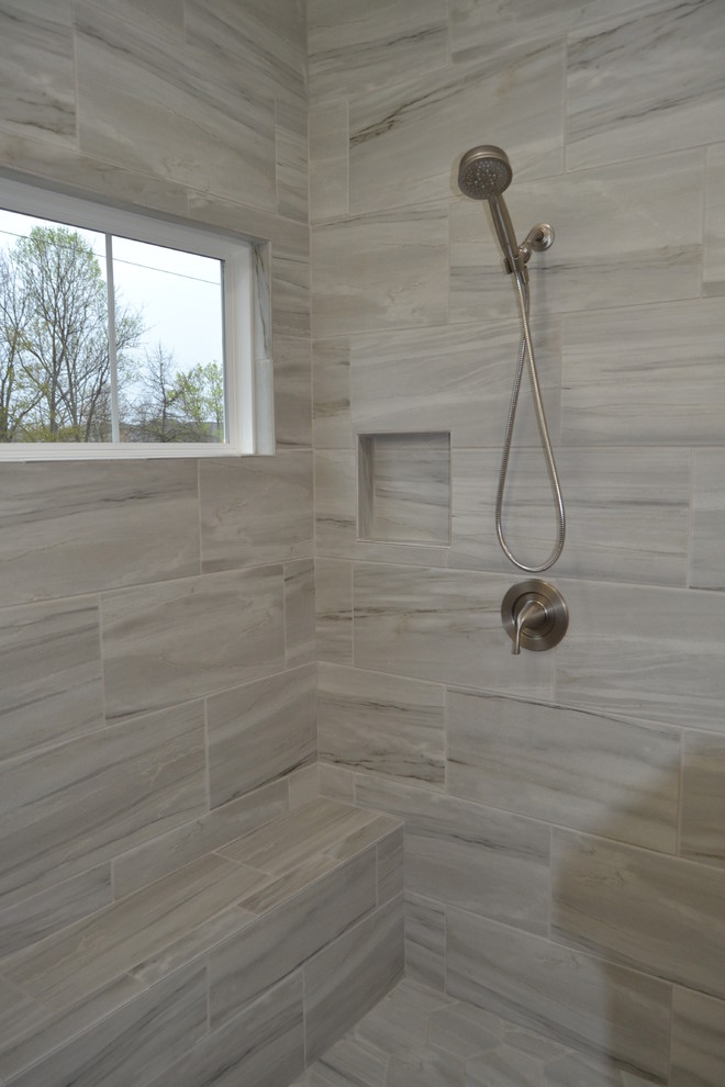 Mid-sized transitional master gray tile and ceramic tile doorless shower photo in Cleveland with granite countertops