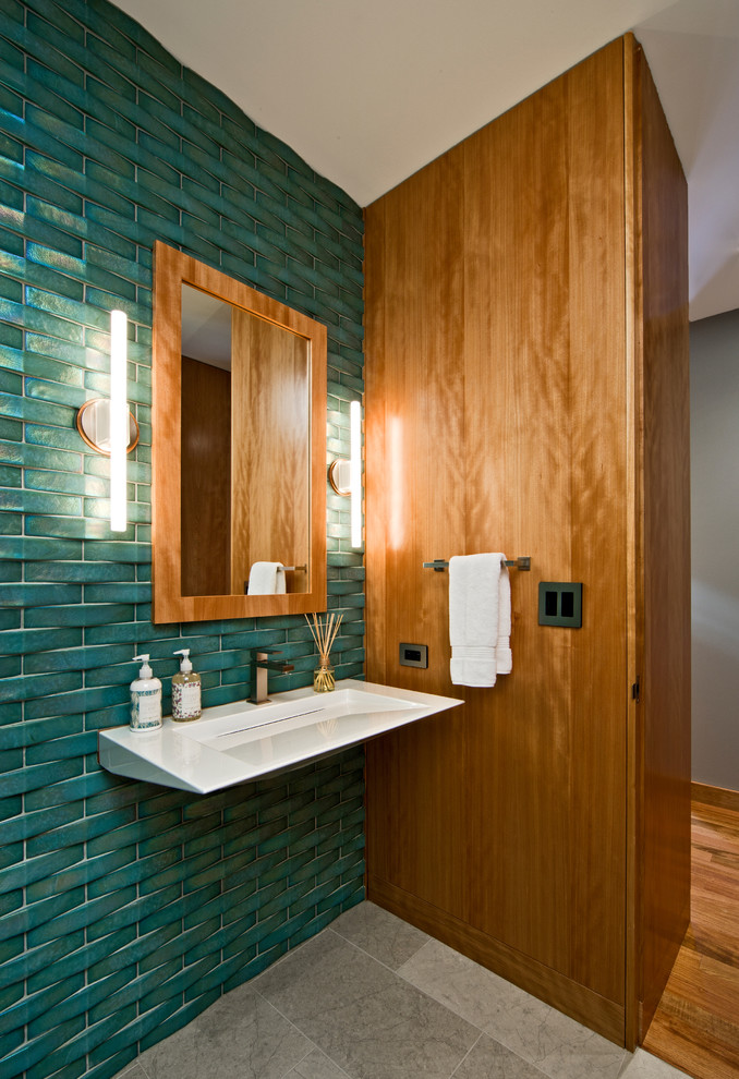 Modern bathroom in Minneapolis with a wall-mounted sink and a feature wall.