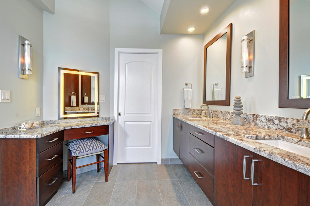 Inspiration for a large coastal master gray tile and porcelain tile pebble tile floor bathroom remodel in Tampa with an undermount sink, flat-panel cabinets, dark wood cabinets, granite countertops, a two-piece toilet and white walls