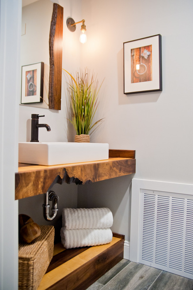 Foto på ett litet funkis brun badrum med dusch, med ett fristående handfat, träbänkskiva, en toalettstol med hel cisternkåpa, mellanmörkt trägolv och vita väggar