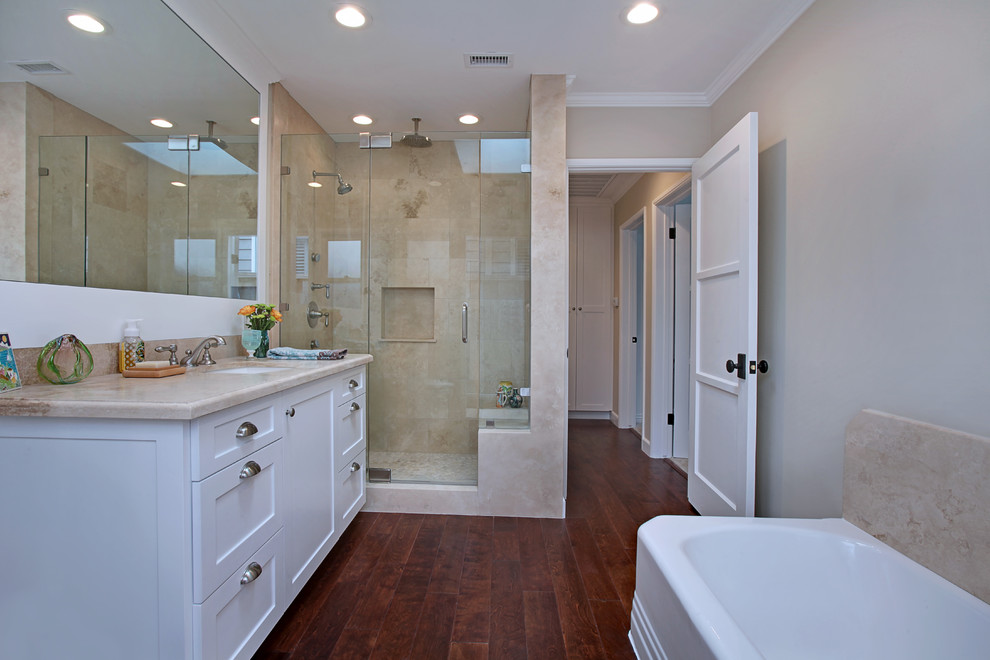 Inspiration for a mid-sized craftsman stone slab and beige tile dark wood floor bathroom remodel in Orange County with shaker cabinets, white cabinets and marble countertops