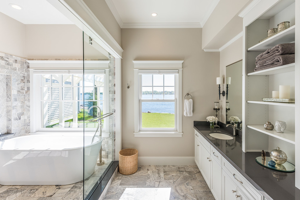 Large elegant master multicolored tile and stone tile porcelain tile bathroom photo in Minneapolis with flat-panel cabinets, white cabinets, an undermount sink, beige walls, solid surface countertops and gray countertops