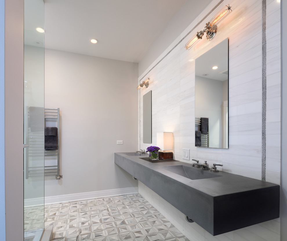 Trendy master gray tile and stone tile mosaic tile floor corner shower photo in Chicago with an integrated sink, concrete countertops, a one-piece toilet and gray walls