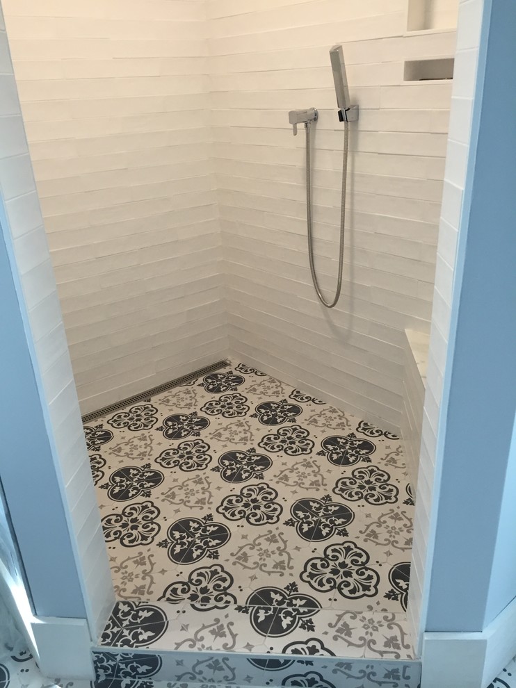 Large traditional ensuite bathroom in Jacksonville with shaker cabinets, white cabinets, a freestanding bath, a walk-in shower, white tiles, blue walls and ceramic flooring.