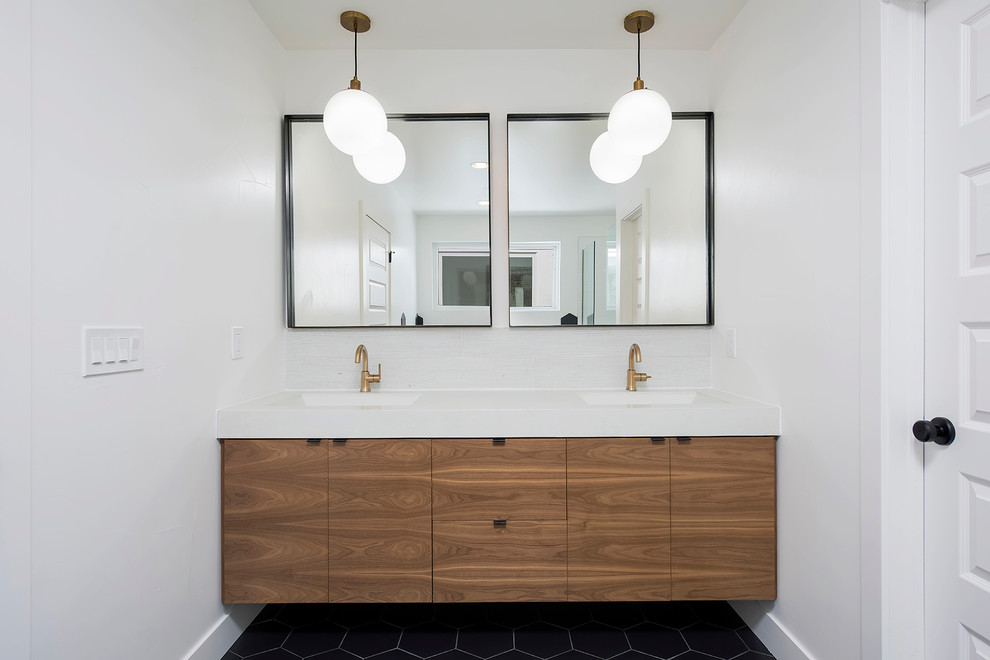 Contemporary bathroom in Denver with flat-panel cabinets, dark wood cabinets, white walls and an integrated sink.