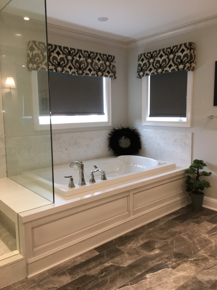 Large elegant master white tile and porcelain tile porcelain tile and gray floor bathroom photo in Toronto with recessed-panel cabinets, distressed cabinets, a one-piece toilet, gray walls, an undermount sink, quartz countertops, a hinged shower door and white countertops