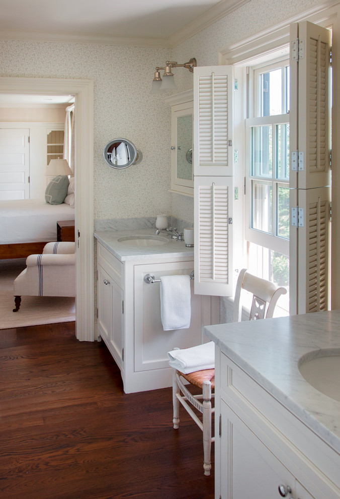 Inspiration for a mid-sized coastal medium tone wood floor bathroom remodel in Boston with an undermount sink, beaded inset cabinets, white cabinets, marble countertops and multicolored walls