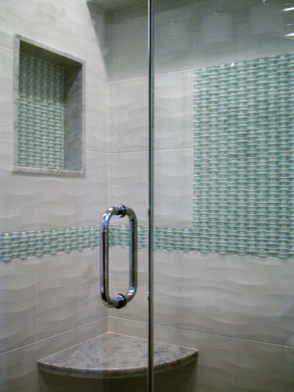This is an example of a medium sized classic ensuite bathroom in New York with a corner shower, blue tiles, white tiles, porcelain tiles and white walls.