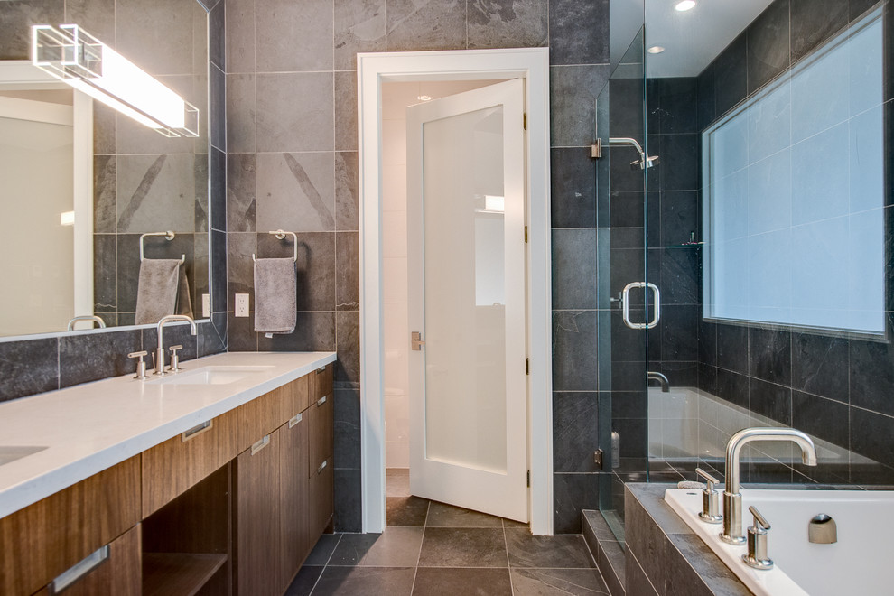 Inspiration for a transitional gray tile corner shower remodel in Vancouver with flat-panel cabinets and dark wood cabinets