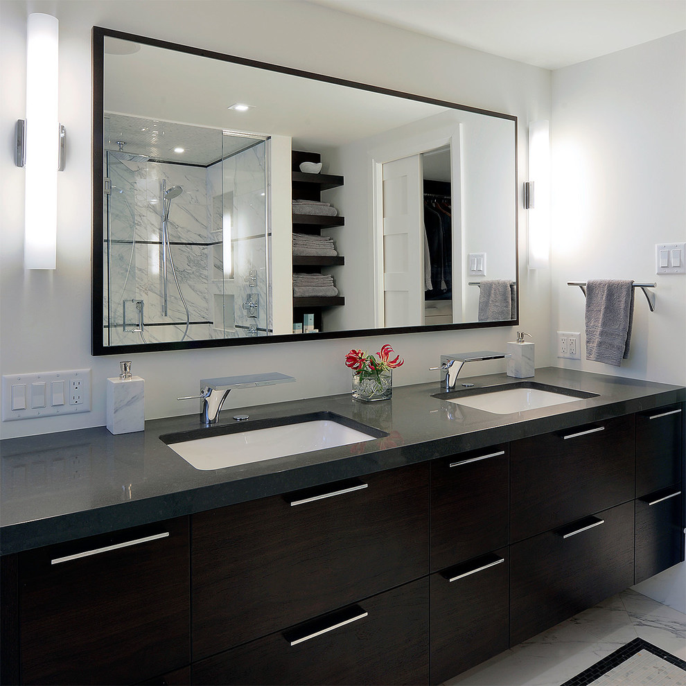 Photo of a large contemporary ensuite bathroom in Ottawa with flat-panel cabinets, dark wood cabinets, an alcove shower, a two-piece toilet, grey walls, marble flooring, a submerged sink, solid surface worktops and a freestanding bath.