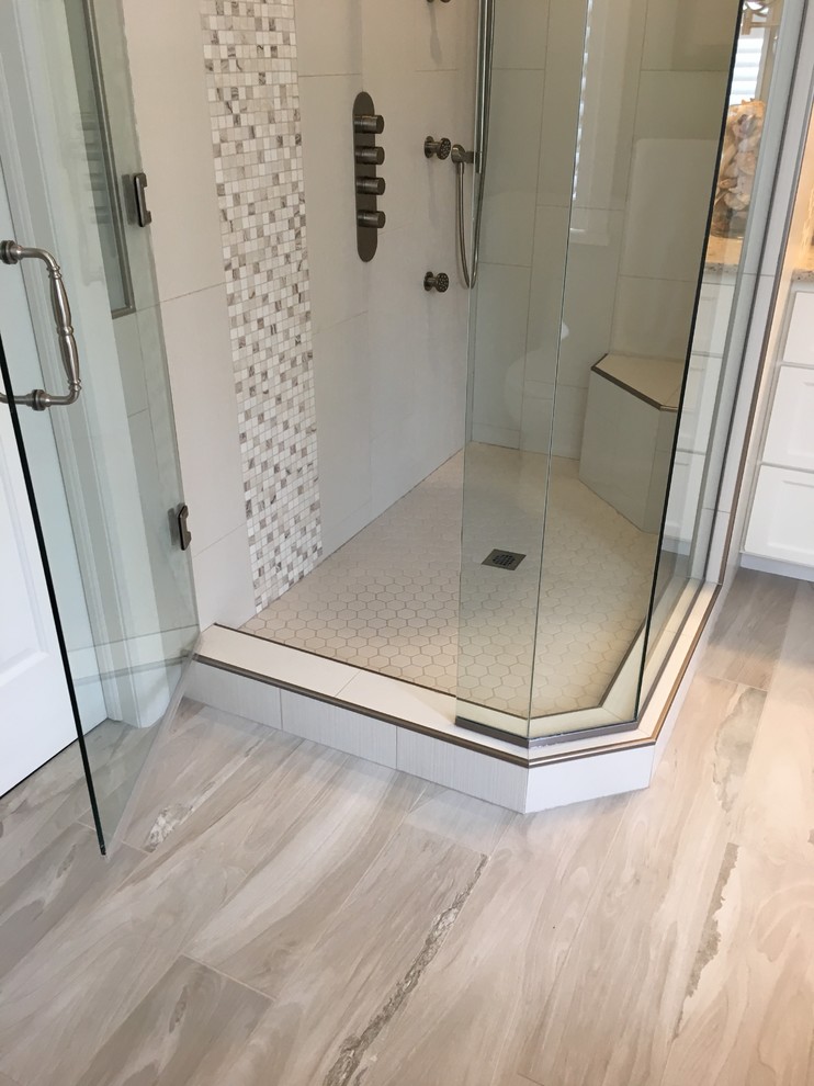 Mid-sized transitional master white tile and porcelain tile porcelain tile and white floor bathroom photo in Other with flat-panel cabinets, white cabinets, a one-piece toilet, white walls, an undermount sink, quartz countertops and a hinged shower door
