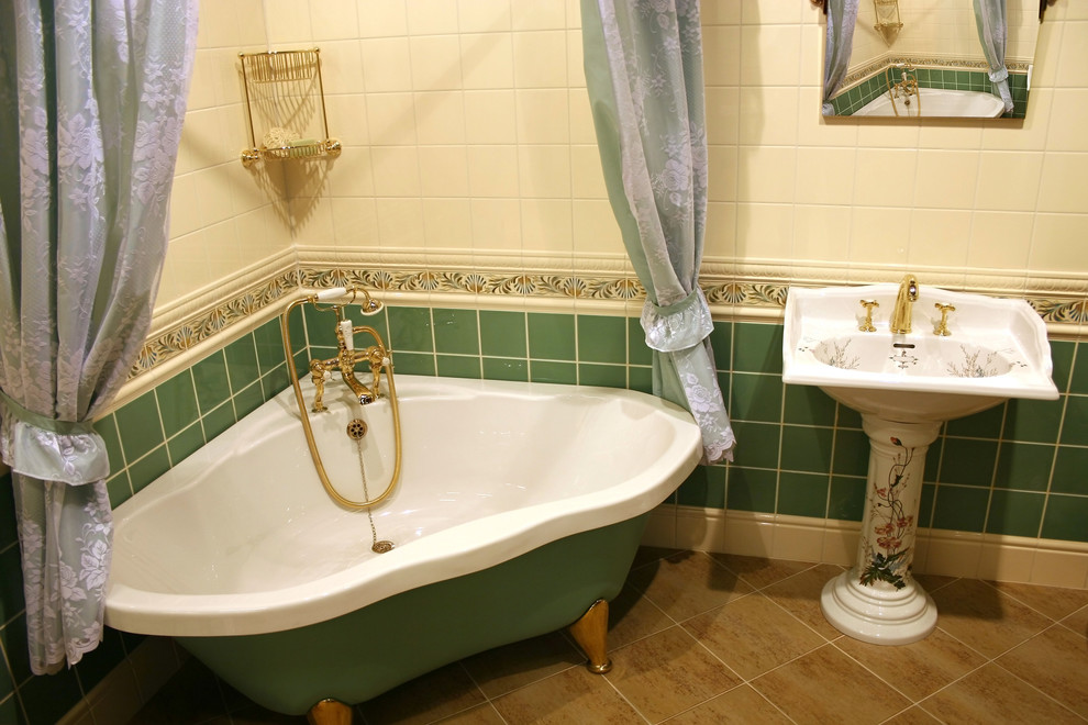 Exempel på ett stort klassiskt en-suite badrum, med ett badkar med tassar, grön kakel, vit kakel, porslinskakel, flerfärgade väggar, klinkergolv i keramik, ett piedestal handfat och brunt golv