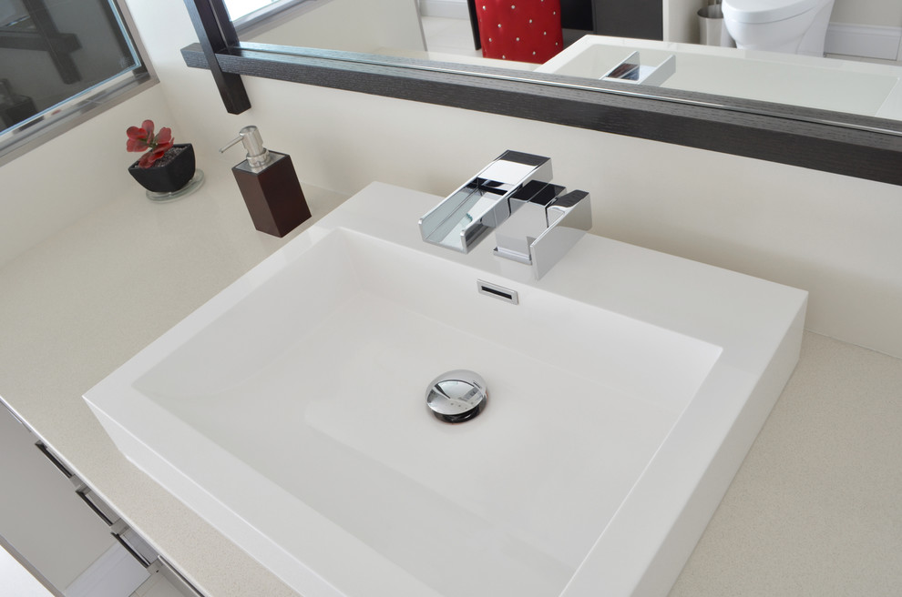Inspiration for a contemporary bathroom remodel in Vancouver with a vessel sink, quartz countertops and white walls