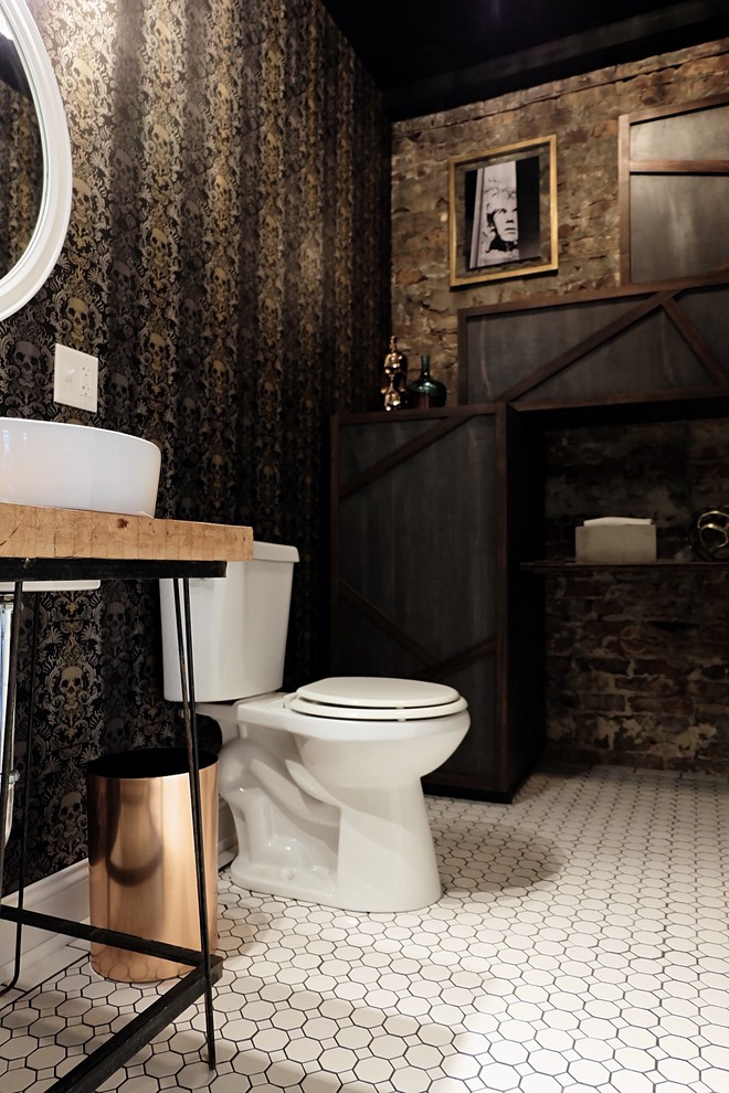 Example of a small eclectic ceramic tile and white floor powder room design in Chicago with flat-panel cabinets, blue cabinets, a two-piece toilet, black walls, a vessel sink and wood countertops