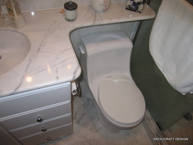 Small minimalist 3/4 white tile and stone tile marble floor alcove shower photo in DC Metro with an undermount sink, raised-panel cabinets, white cabinets, a one-piece toilet and white walls