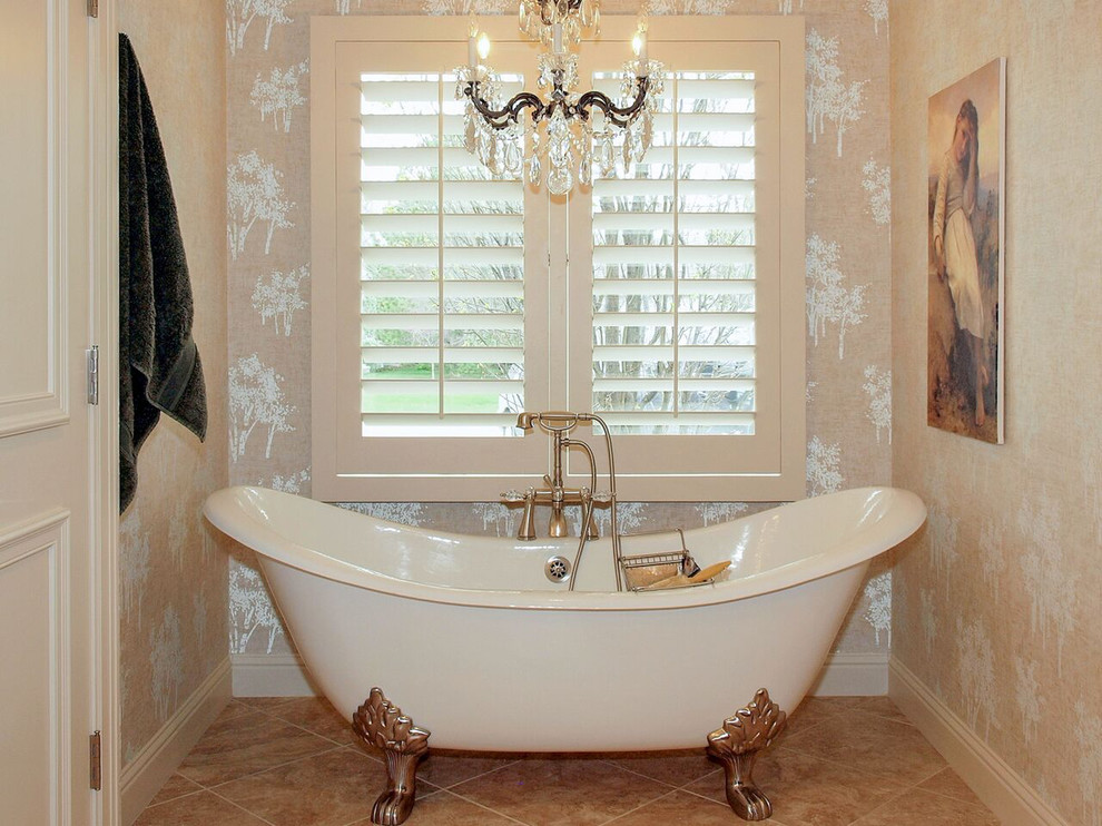 Example of a mid-sized ornate master travertine floor freestanding bathtub design in Wichita with beige walls