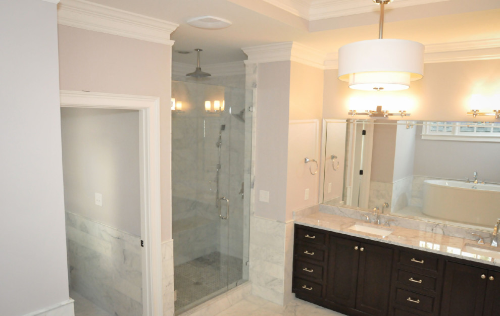 This is an example of a large classic ensuite bathroom in Atlanta with shaker cabinets, dark wood cabinets, an alcove shower, grey tiles, white tiles, marble tiles, beige walls, marble flooring, a submerged sink, marble worktops, grey floors and a hinged door.