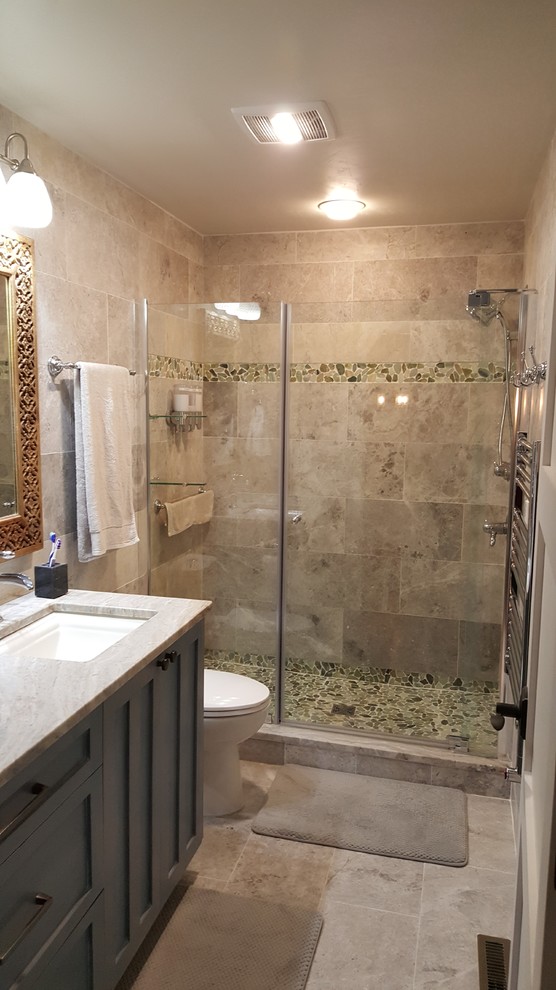 Photo of a medium sized classic bathroom in Milwaukee with shaker cabinets, brown cabinets, an alcove shower, pebble tiles, beige walls, porcelain flooring, a submerged sink and granite worktops.