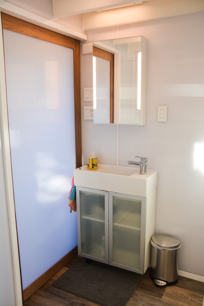 Modern inredning av ett en-suite badrum, med ett platsbyggt badkar, en dusch/badkar-kombination, vita väggar, vinylgolv och ett fristående handfat