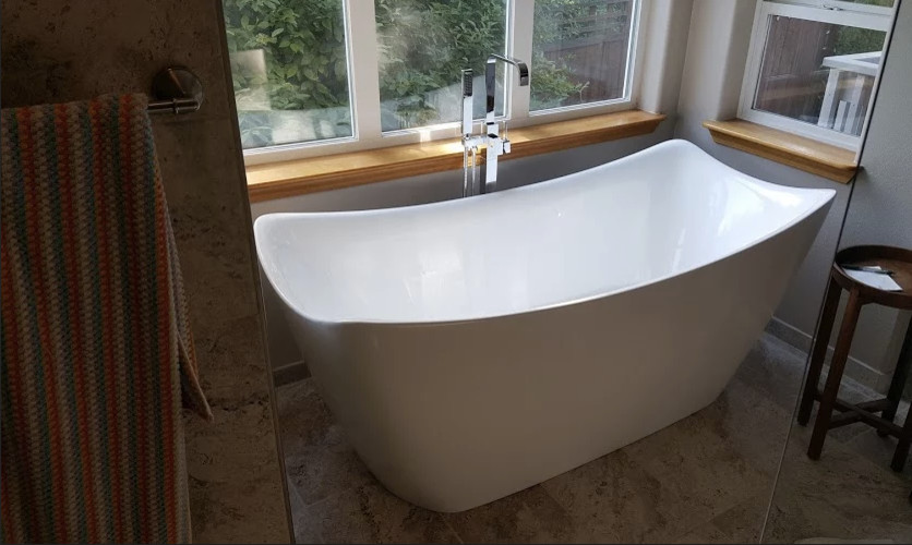 Photo of a large contemporary bathroom in Seattle with a freestanding bath and porcelain flooring.