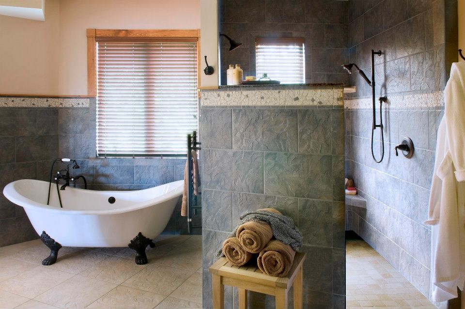 Design ideas for a large rustic ensuite bathroom in Burlington with a claw-foot bath, a built-in shower, multi-coloured tiles, ceramic tiles, multi-coloured walls, ceramic flooring and grey cabinets.