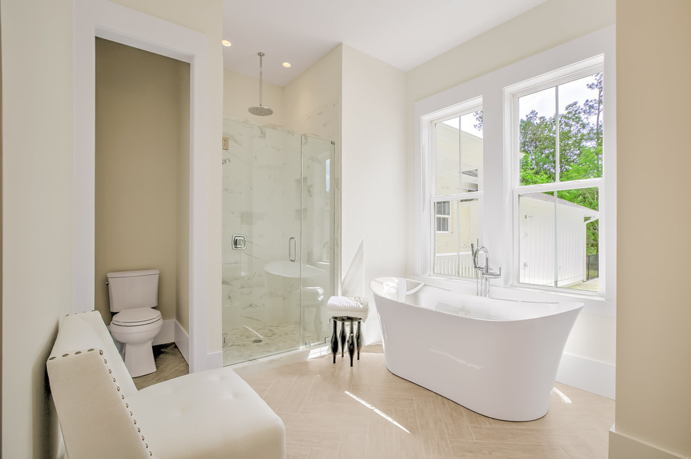 Photo of a medium sized contemporary ensuite bathroom in Other with a freestanding bath, a one-piece toilet, beige walls, an alcove shower and porcelain flooring.