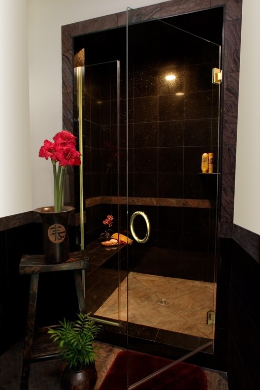 Example of a small 3/4 black tile and porcelain tile alcove shower design in Los Angeles with white walls