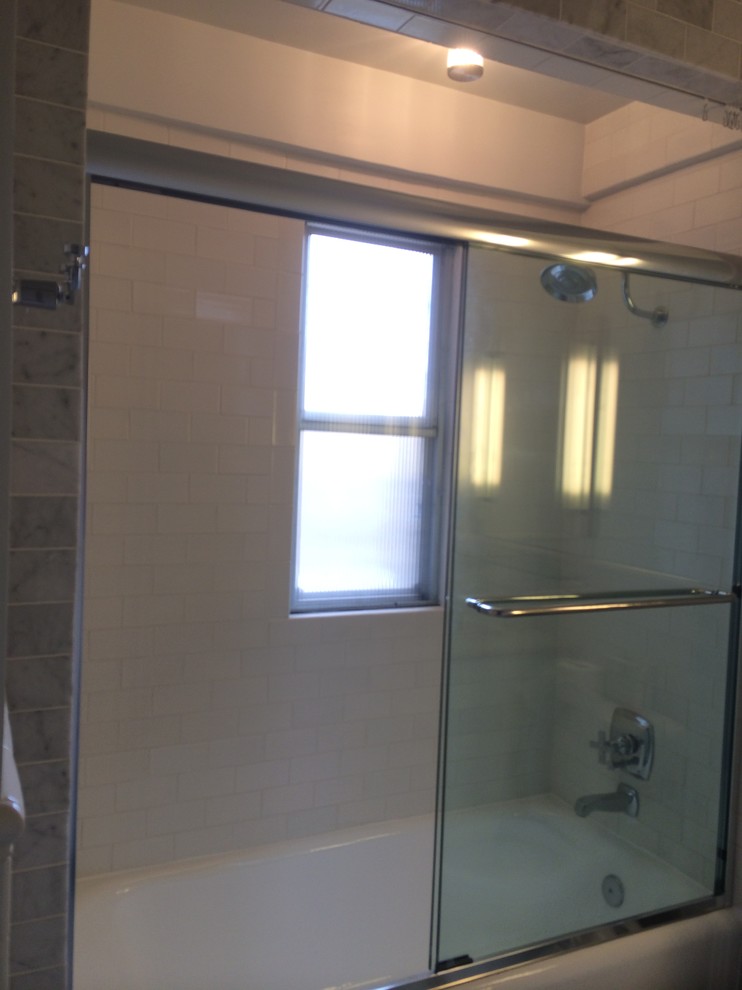 Medium sized contemporary shower room bathroom in Orange County with flat-panel cabinets, white cabinets, an alcove bath, a shower/bath combination, a one-piece toilet, white tiles, white walls, porcelain flooring, a submerged sink, engineered stone worktops, grey floors and a sliding door.